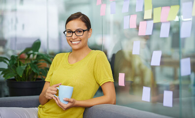 Canvas Print - Im having a sneaky second cup. Attractive female office worker sneaking in a second cup of coffee on her break.