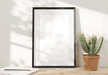 Aufkleber - Black frame leaning on white shelve in bright interior with plants mockup 3D rendering