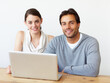 © Laflor/peopleimages.com - Perfect working companions. Portrait of a handsome man and a beautiful young woman working together on a laptop.