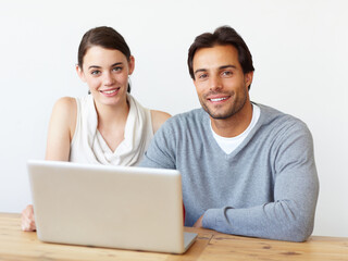 Poster - Perfect working companions. Portrait of a handsome man and a beautiful young woman working together on a laptop.