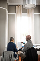 Poster - Will we make it through the month with this budget. Shot of a senior couple working on their finances at home.