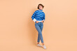 © deagreez - Full length photo of satisfied glad person put arms pockets toothy smile isolated on beige color background