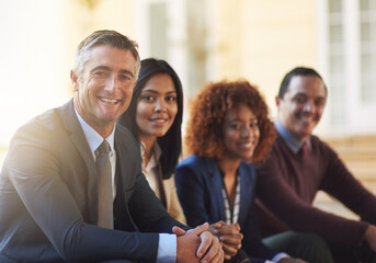 The faces of new business. Cropped portrait of a group of coworkers sitting outside.