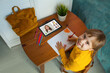 © millaf - Portrait of adorable child with digital tablet. Remote education, online school and student little girl at home