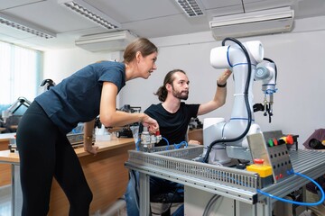 An engineer in research development robotic factory checking prototype of automation robot arm