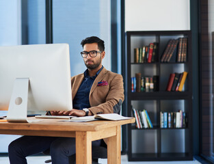 Aufkleber - Guided to success by his keen business intuition. Cropped shot of a young businessman working on a computer in an office.