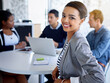 © Yuri A/peopleimages.com - I have the best job ever. Portrait of a young businesswoman with colleagues in the background.