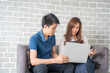© themorningglory - Business man and woman working in office wioth laptop brainstorm business plan