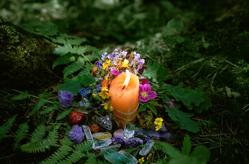 Poster - Сandle, minerals, amulet, flowers on dark forest natural background. Magic, Witchcraft, spiritual practice. pagan, Wiccan, Slavic traditions. esoteric ritual for Midsummer, Litha