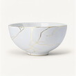 © Stock'd  - Kintsugi porcelain bowl repaired with gold cracks, on white background, made with generative ai