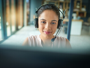 Canvas Print - Please hold while I connect your call. Shot of a young woman working in a call center.