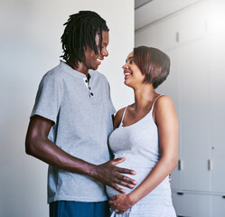 Wall Mural - He gets excited when I touch your belly. Shot of a young man touching his pregnant wifes belly.