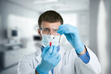 Poster - Young doctor with medical vial in hand