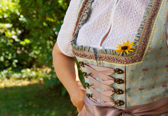 Wall Mural - a German woman in a beautiful traditional Bavarian dirndl or also Austrian dirndl (also called Tracht) usually worn at the Bavarian October fest (Oktoberfest) (Munich, Bavaria, Germany)	