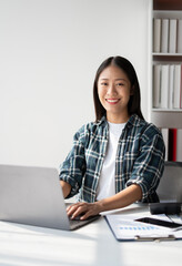 Poster - Creative young woman working on laptop in her studio.