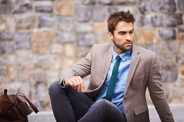 Wall Mural - Styled on point. Shot of a handsome and stylish young businessman in an urban setting.