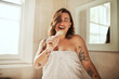 © Chanelle M/peopleimages.com - How rock stars get ready for the day. Shot of an attractive young woman singing while going through her morning beauty routine at home.