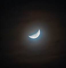 Wall Mural - Blue Moon in the night sky - colored by the refraction and dispersion of light in the clouds