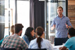 © Laflor/peopleimages.com - Hes got some great marketing insights. Shot of a male designer presenting his ideas to his team in a meeting.
