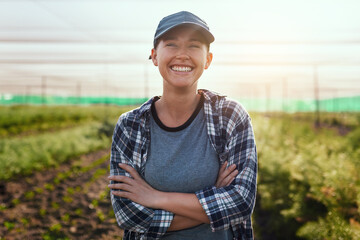 the farm life is the life for me. cropped portrait of an attractive young female farmer standing wit