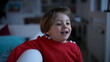 © Marco - Portrait of a happy small boy closeup face standing indoors at home living room. 2 year old child wearing red sweater