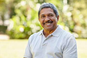 The golden years are great. Portrait of a happy senior man enjoying a day outdoors.