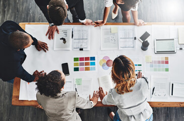 Wall Mural - They have lots of ideas to wrap their heads around. High angle shot of a group of businesspeople having a meeting in an office.