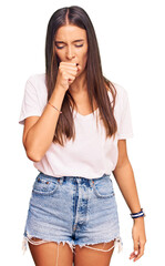 Wall Mural - Young hispanic woman wearing casual white tshirt feeling unwell and coughing as symptom for cold or bronchitis. health care concept.