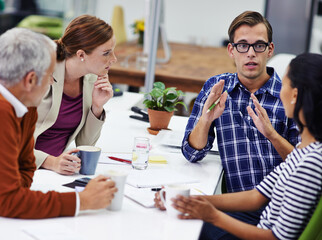 Poster - Hes got vision. A cropped shot of a group of professionals having a meeting at work.