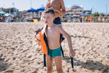 Little Boy Standing On Sandy Beach