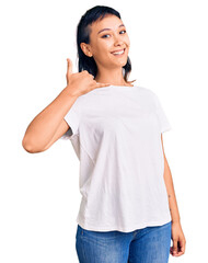 Sticker - Young woman wearing casual clothes smiling doing phone gesture with hand and fingers like talking on the telephone. communicating concepts.