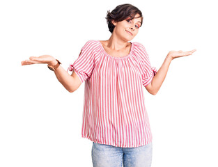 Poster - Beautiful young woman with short hair wearing casual summer clothes clueless and confused expression with arms and hands raised. doubt concept.