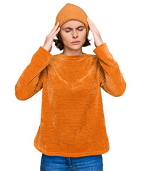 Canvas Print - Young hispanic woman wearing casual clothes and wool cap with hand on head for pain in head because stress. suffering migraine.