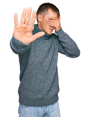 Poster - Young blond man wearing casual clothes covering eyes with hands and doing stop gesture with sad and fear expression. embarrassed and negative concept.