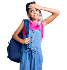 Canvas Print - Cute african american girl holding student backpack using backpack stressed and frustrated with hand on head, surprised and angry face