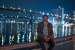 Afro American Man at Brooklyn Bridge by night - street photoraphy