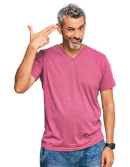 Sticker - Middle age grey-haired man wearing casual clothes shooting and killing oneself pointing hand and fingers to head like gun, suicide gesture.