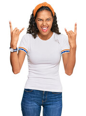 Canvas Print - Young african american girl wearing casual clothes shouting with crazy expression doing rock symbol with hands up. music star. heavy music concept.