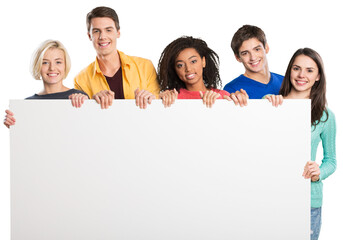 Wall Mural - Group of diverse multiethnic happy young people posing with a blank white rectabgular sign with copyspace for your advertisement or text on a grey background