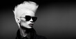 A stylish and modern portrait of an albino, androgynous woman in a black-and-white jacket with sunglasses. A smart unisex fashion shot. Generative AI.