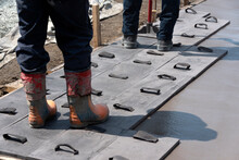 Workers Stamping A Concrete Floor