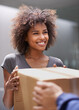© Mapodile/peopleimages.com - Delivering direct to your door. Shot of a courier making a delivery to a smiling customer.