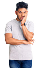 Sticker - Handsome latin american young man wearing casual tshirt thinking looking tired and bored with depression problems with crossed arms.