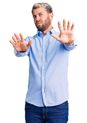 Poster - Young handsome blond man wearing elegant shirt doing stop gesture with hands palms, angry and frustration expression