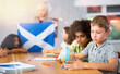 © JackF - Kids learning together about scotland in geography class