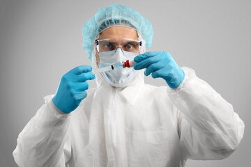 Poster - Young doctor with test tube in hand