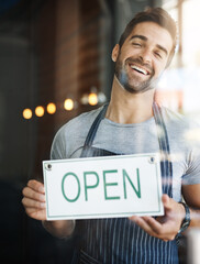 Poster - Lets get you some coffee. Shot of a handsome young man hanging up an open sign on the door of his store.