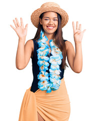 Sticker - Young beautiful latin girl wearing hawaiian lei and summer hat showing and pointing up with fingers number nine while smiling confident and happy.