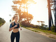 © Delmaine D/peopleimages.com - Run your own race. Shot of a fit young woman going for a run outdoors.