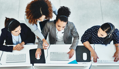 Wall Mural - its just easier to resolve the issue together. high angle shot of a group of women working in a call